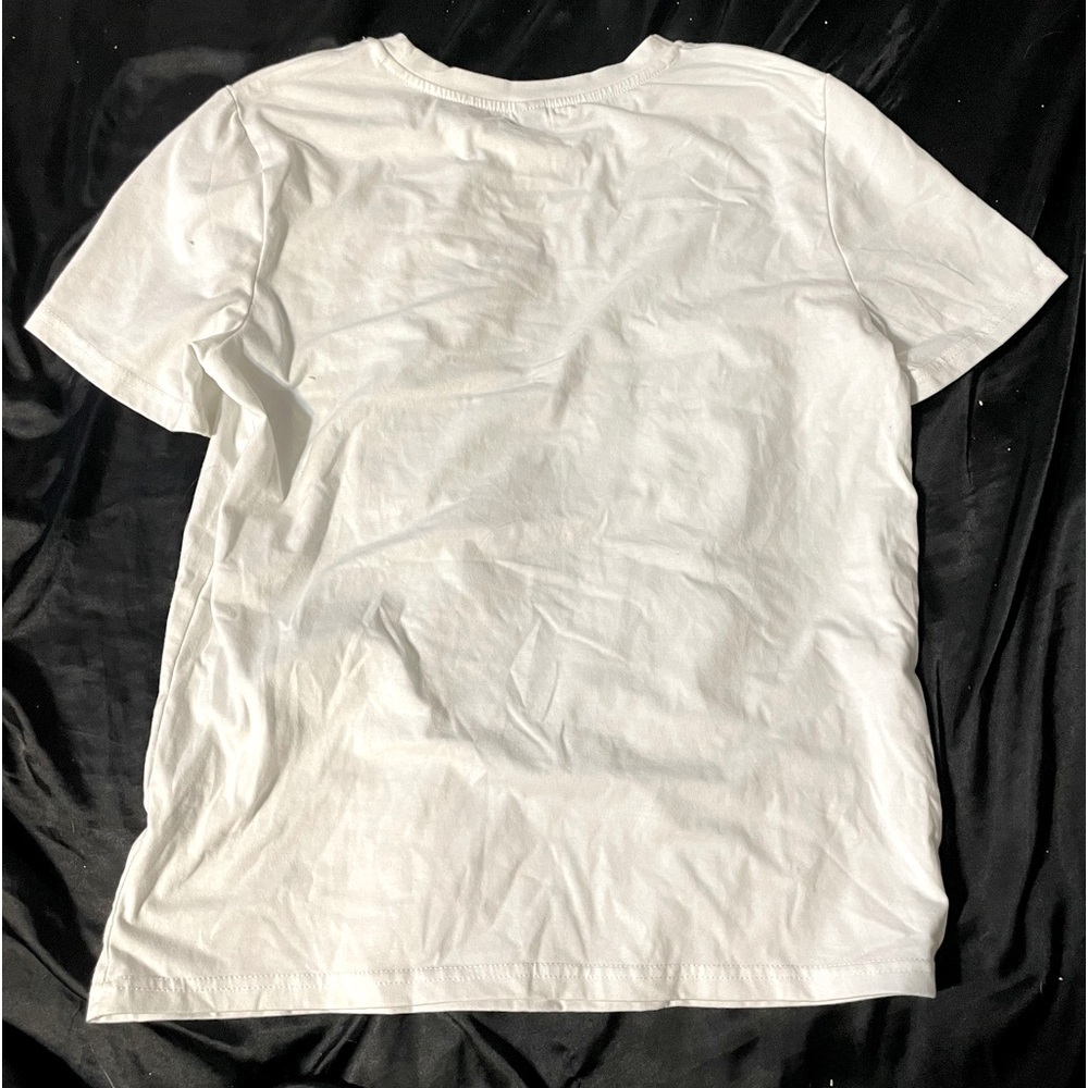 This shirt is white and black from SHEIN, it’s in a size small in women’s.